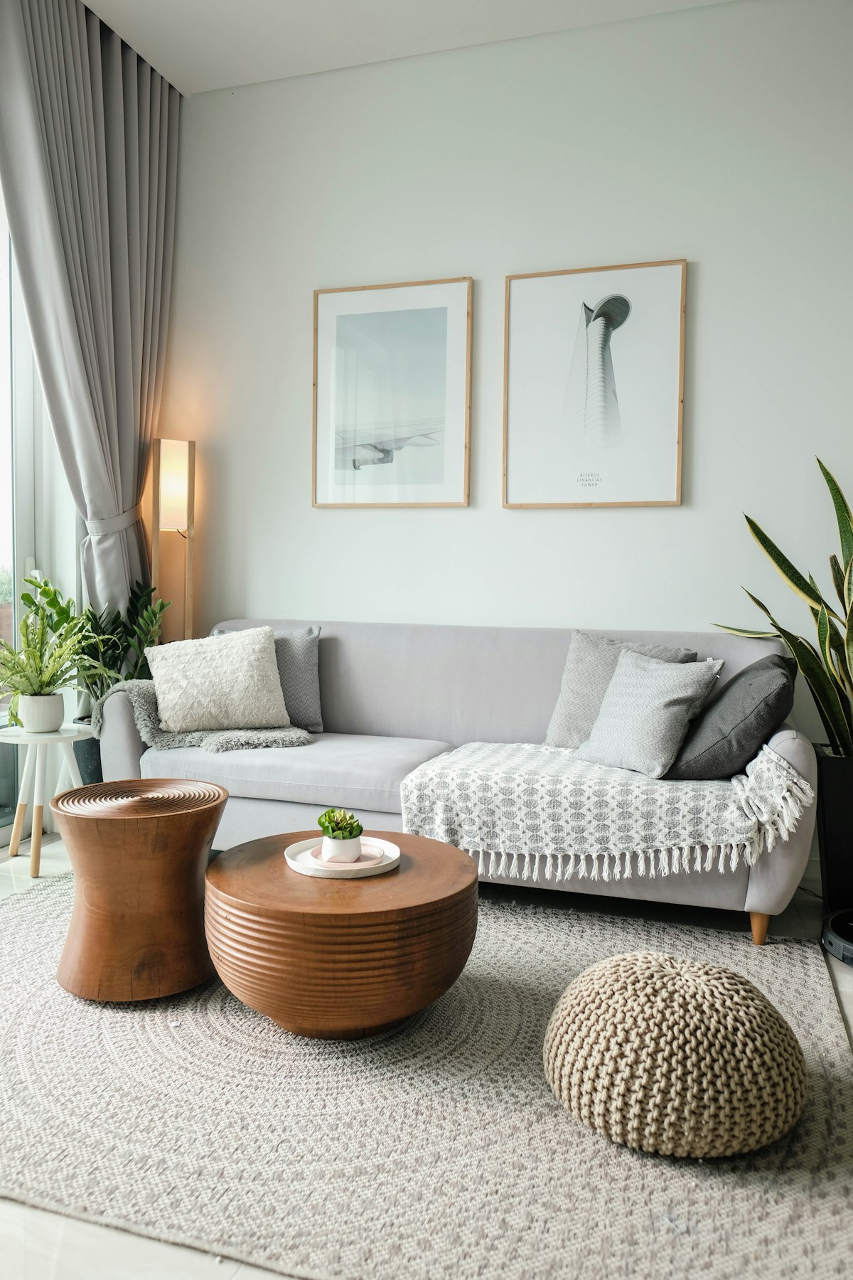 Wooden coffee tables and a knit pouf in a warm living room